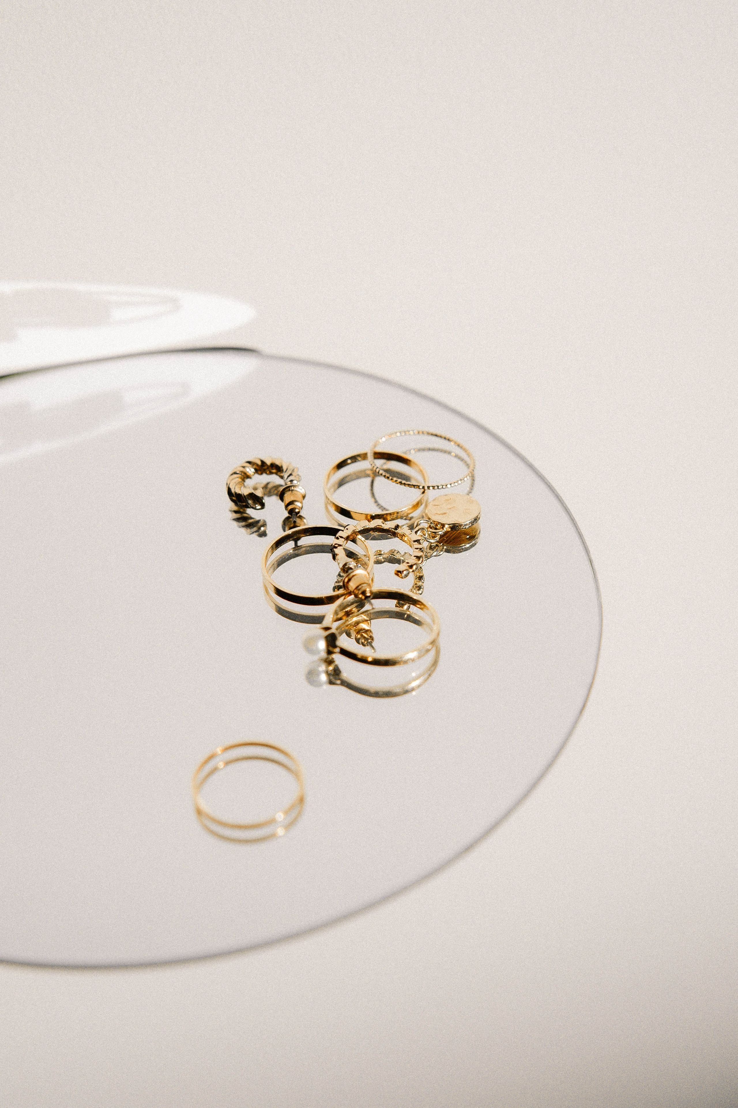 Gold rings arranged on a reflective surface
