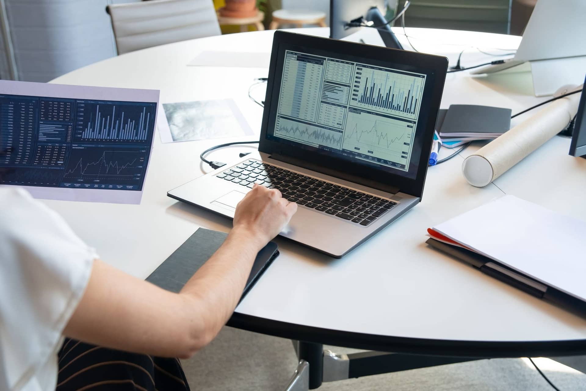 A business dashboard open on a laptop in a bright office